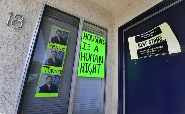 Signs and posters are seen on an apartment block where, with no rent control due to the year it was built, the landlord has i