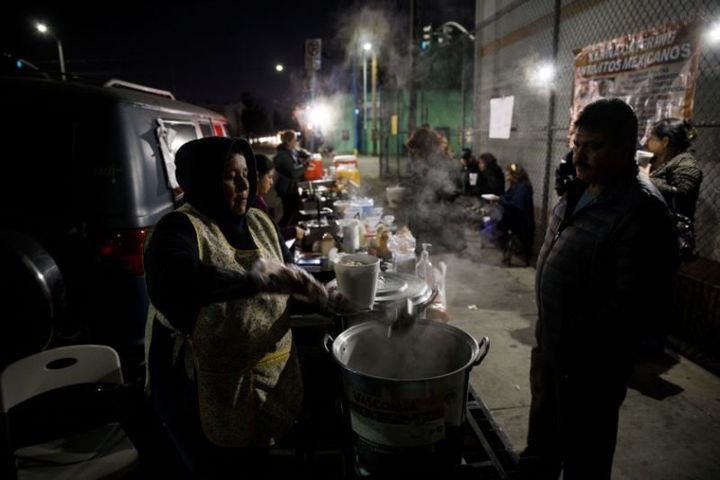 A food vendor of more than a decade serves pozole from a sidewalk grill in February in Boyle Heights, Los Angeles. 