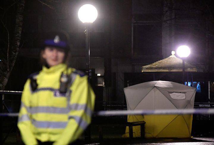 Police officers stand guard beside a cordoned-off area in Salisbury.