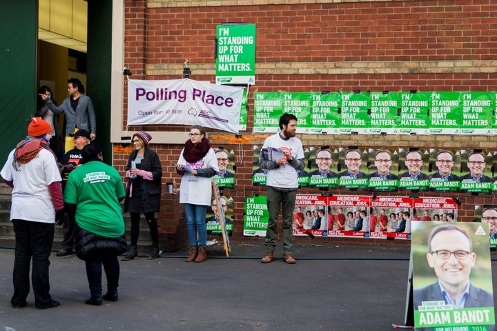 Volunteers hand out voting instruction cards on election day in Melbourne, Australia, on July 2, 2016.