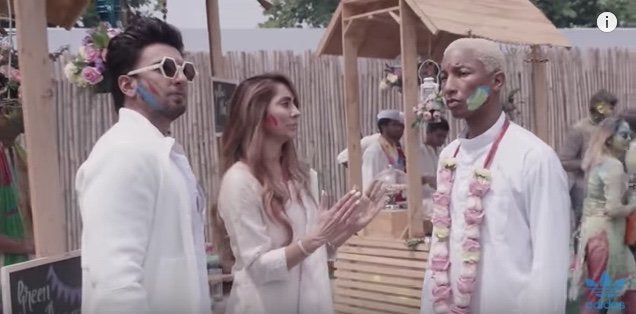 Pharrell Williams listens as Bollywood star Ranveer Singh and presenter Anusha Dandekar explain Holi, a Hindu spring festival.