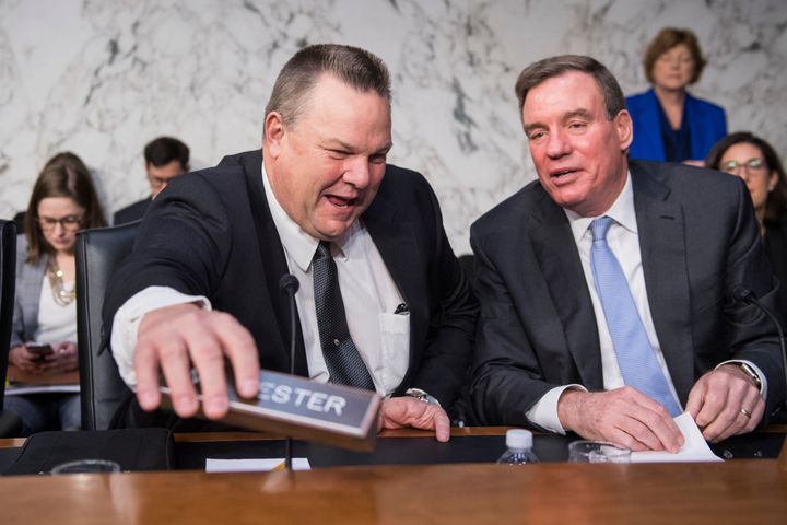 Democrats Jon Tester (left) and Mark Warner, both members of the Senate Banking Committee, support the bill.