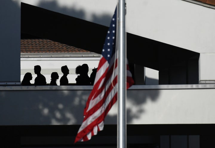 A flag flies at half-staff as students return to Marjory Stoneman Douglas High School on Wednesday February 28 in Parkland, Florida.