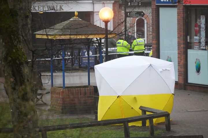 Police officers at the cordoned off scene where Skripal and his daughter were found; the tent conceals the park bench they were found on