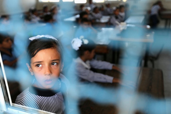 A Palestinian girl attends a lesson on the first day of the new school year at a United Nation-run school in the Gaza Strip.