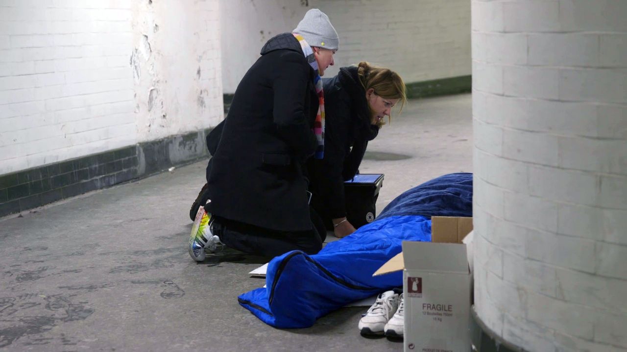 Outreach workers from St Mungo's homeless charity talk to a homeless person in London during the cold snap last week