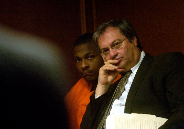 Robert Ray, center, listens after being indicted for double homicide at Arapahoe County Court on Monday March. 13, 2006.