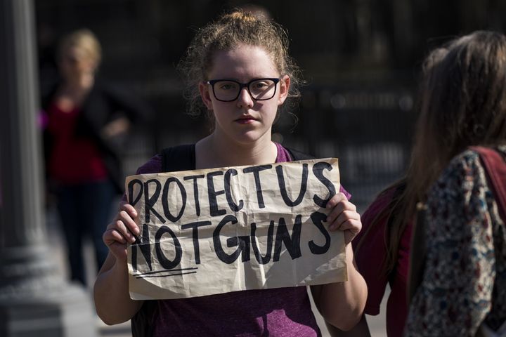 A student holds a sign as hundreds of students rally for stronger gun control laws outside the White House on Feb. 21, 2018.