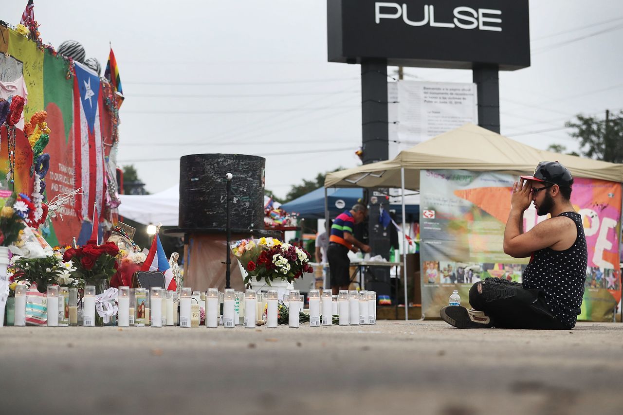 Jose Ramirez, a survivor of the Pulse massacre, reacts as he visits the site one year after the shooting.
