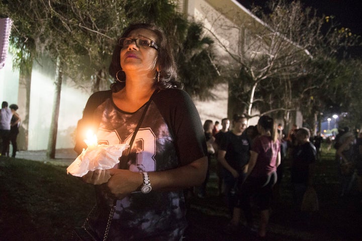 Donna Ali, mother of Marjory Stoneman Douglas High School student Arianna Ali, holds a candle at a vigil mourning those who died.