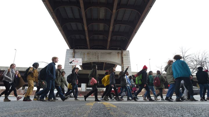 Students from Baltimore School for the Arts walk along Guilford Avenue on their way to City Hall on Tuesday.