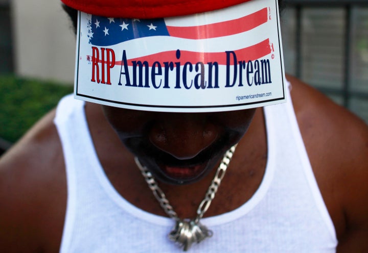 A member of Occupy Wall Street protesting on 5th Avenue in October 2011. A new report has found racial inequality has worsened over the last 50 years.