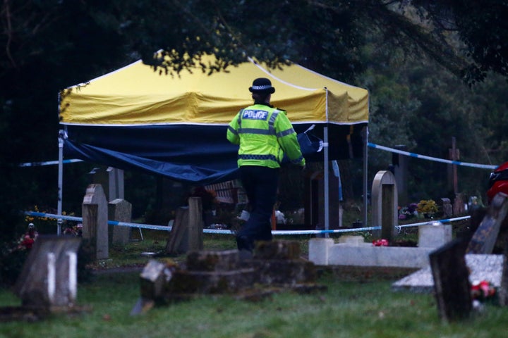 A police officer walks past a forensics tent over the grave of former Russian double agent Sergei Skripal's wife Lyudmila