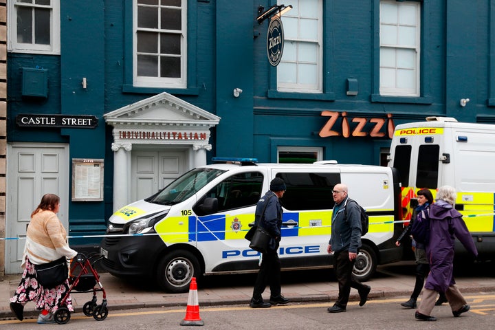 Pedestrians walk past a cordoned-off branch of the Italian chain restaurant Zizzi close to The Maltings shopping centre in Salisbury