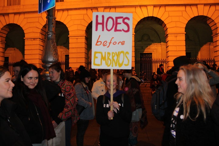 A protester raises a sign that reads