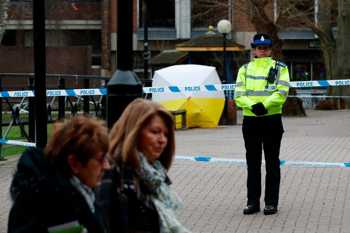 <strong>A police officer guards a police cordon in front of the bench covered in a protective tent in The Maltings shopping centre in Salibury</strong>
