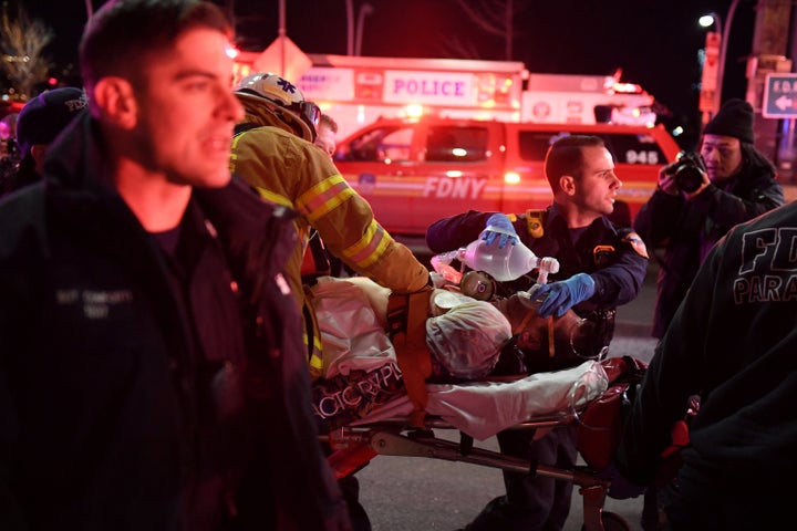 Paramedics and members of the NYFD perform CPR on a victim of a helicopter crash in New York City on Sunday.