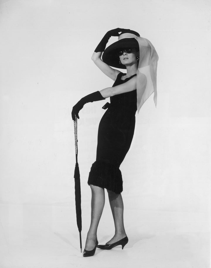 Actress Audrey Hepburn wears the black cocktail dress designed by French couturier Hubert de Givenchy in a promotional p