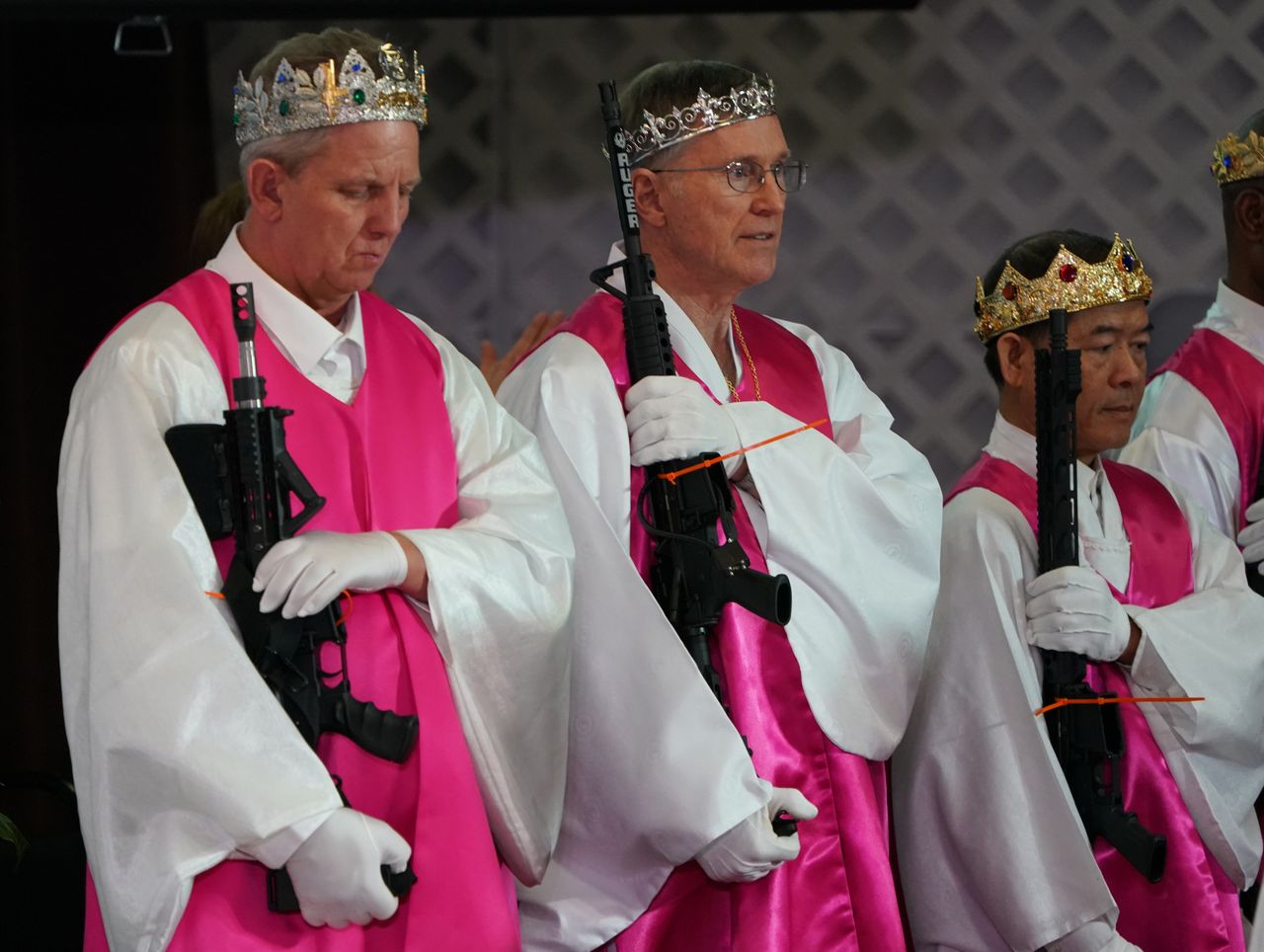 Worshippers at World Peace and Unification Sanctuary hold weapons during their "commitment" service Feb. 28 in Newfoundland, Pennsylvania. Those who embrace guns often are searching for a form of empowerment.