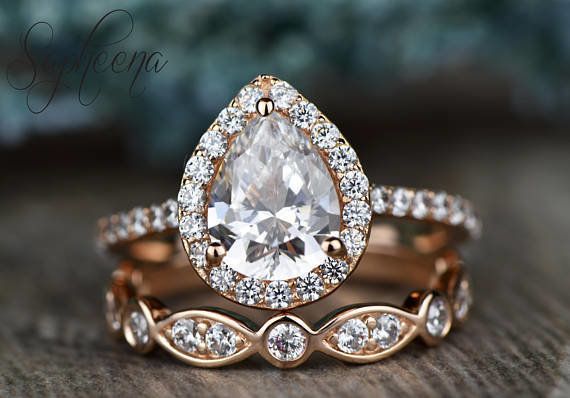 This pear-shaped moissanite engagement ring by seller Sapheena on Etsy also features a moissanite halo. 