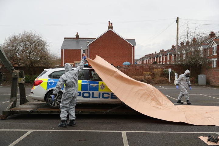 A police car being taken away by military personnel from College Street Car Park in Salisbury, as police and members of the armed forces probe the nerve agent attack on Sergei Skripal.