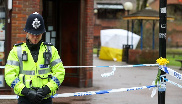 A police officer stands in Salisbury near the bench where the Skripals were found