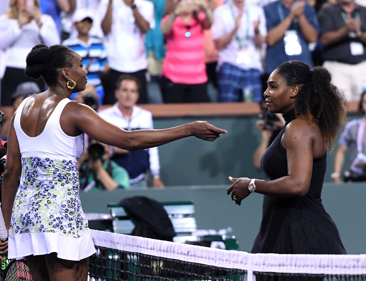 Venus Williams (L) hugs Serena Williams after her win over her sister during Day 8 of BNP Paribas Open on March 12, 2018 in Indian Wells, California.