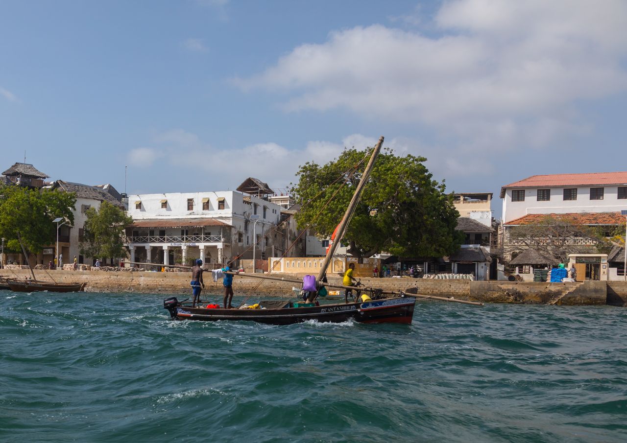 A dhow is guided in from the old town in Lamu, Kenya. The town may soon be the site of the country's first coal plant.