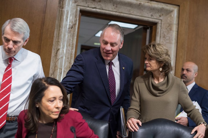 Interior Secretary Ryan Zinke, center, arrives to testify at a Senate Energy and Natural Resources Committee hearing on Tuesd