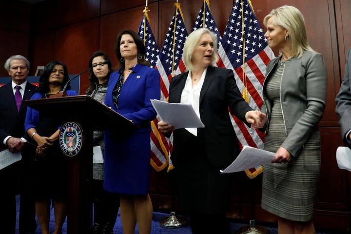 Rep. Cheri Bustos (D-Ill.) speaks at a press conference calling for an end to forced arbitration as Sen. Kirsten Gillibrand (D-N.Y.) greets Gretchen Carlson on Capitol Hill on Dec. 6, 2017.