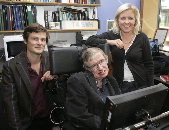 Professor Stephen Hawking, (C) his daughter Lucy (R) and Christophe Galfard pose for photographs in Professor Hawking's office at The Centre for Mathematical Sciences in Cambridge, in central England, 03 September 2007.