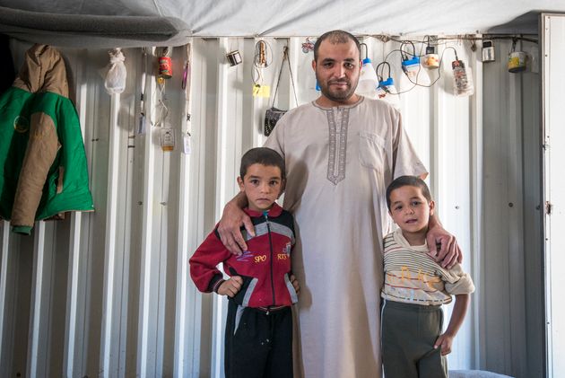 Abu Ahmad helped another community member, Mustafa, install a sunshade. In exchange he and his sons got a haircut.