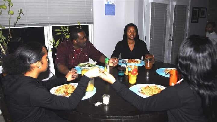 Tonia Wellons, vice president for a Washington, D.C., community foundation, prepares to say grace with her family in Prince G