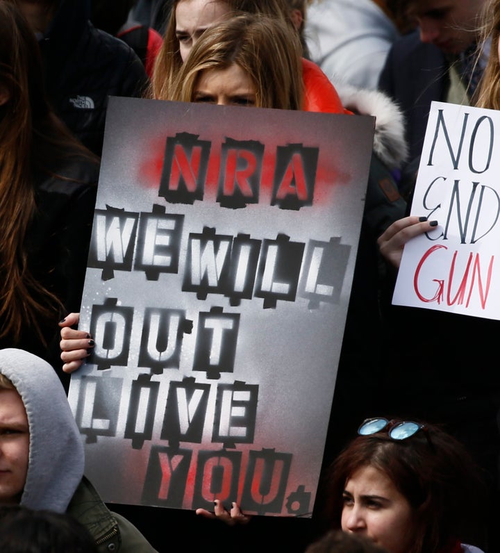 A sign reading "NRA We Will Out Live You" is held during a protest in Washington, D.C. on Wednesday.