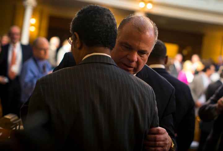 New Jersey state Senate President Stephen Sweeney grabs hold of a colleague on the floor of the legislative chamber in February 2015.