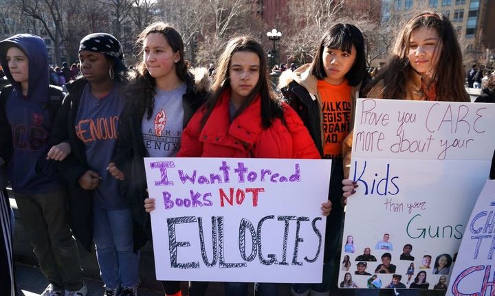 “I want to read books not eulogies” Students from Harvest Collegiate High School form a circle around the fountain in Washington Square Park on March 14, 2018, in New York City to take part in a national walkout to protest gun violence, one month after the shooting in Parkland, Fla., in which 17 people were killed. 