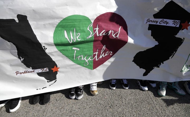 Students from James Ferris High School hold a banner outside of the school during a student walkout in Jersey City, N.J. 