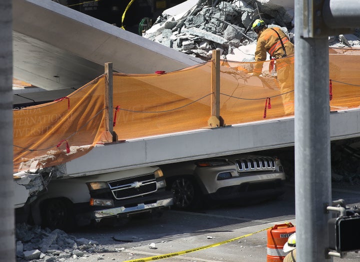 Vehicles are trapped under the collapsed pedestrian bridge in Miami.