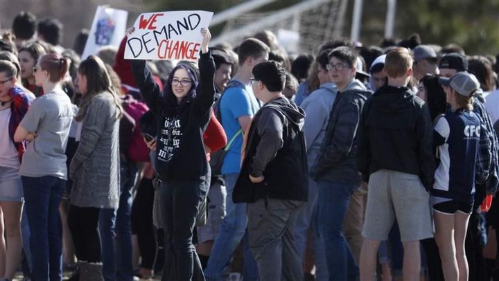 Columbine High School students stage a walkout Wednesday, part of a national student protest against gun violence. The Columbine shooting in 1999 spurred Colorado’s creation of a statewide anonymous tip line.