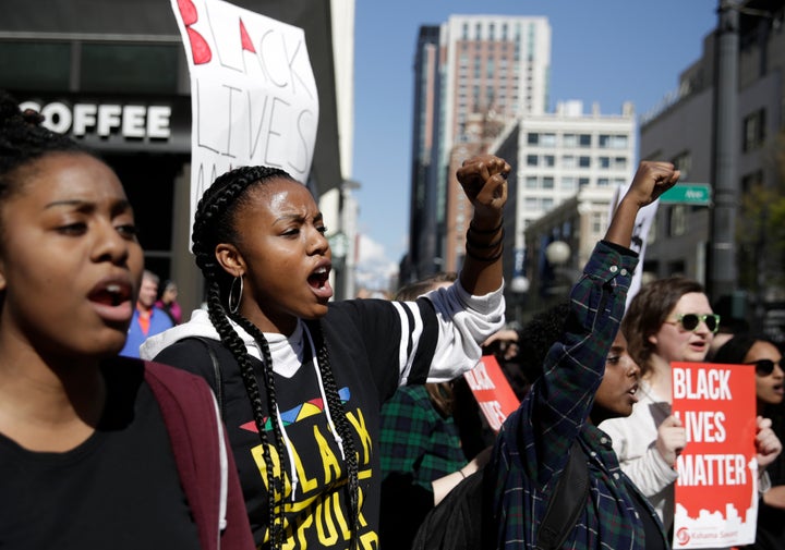 People carry signs and march at a Black Lives Matter protest in Seattle, Washington, in April 2017.