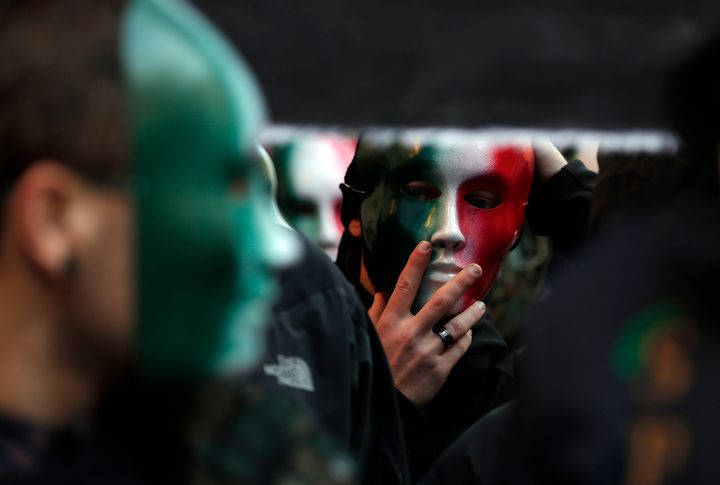 A member of Casapound far-right organization wears a mask in the green, white and red colours of the Italian flag before a demonstration organised by "People from pitchfork movement" to protest against economic insecurity and the government in downtown Rome 