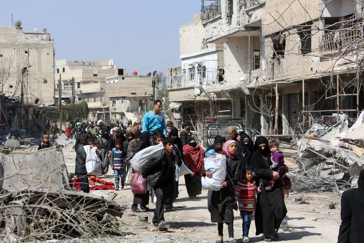 Syrian civilians evacuate from the town of Jisreen in the southern Eastern Ghouta, on the eastern outskirts of the capital Damascus, on their way to areas under government control on March 17, 2018.