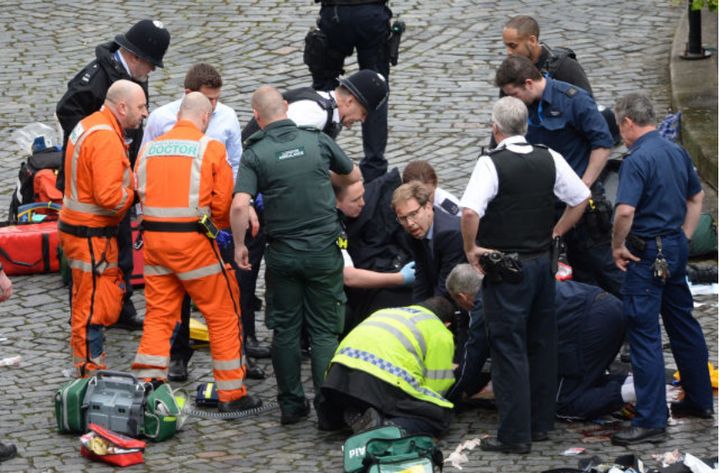 MP Tobias Ellwood pictured, middle, trying to save the life of Pc Keith Palmer