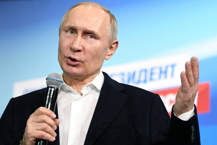 Vladimir Putin speaks as he meets with confidants at his campaign headquarters in Moscow on March 18
