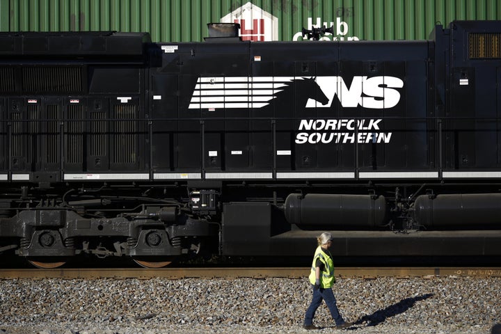 A conductor walks past a Norfolk Southern Railway Corp. freight locomotive in Burnside, Kentucky. Two of the company's trains were involved in a collision near Lexington on Sunday night.