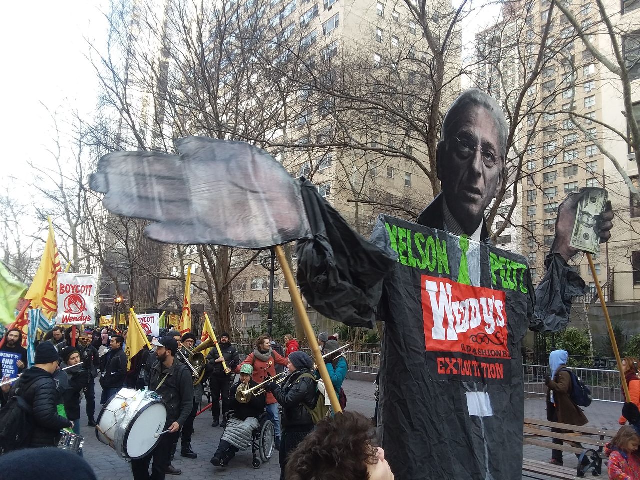 Protesters carry a puppet of Wendy’s board chairman and hedge fund investor Nelson Peltz.