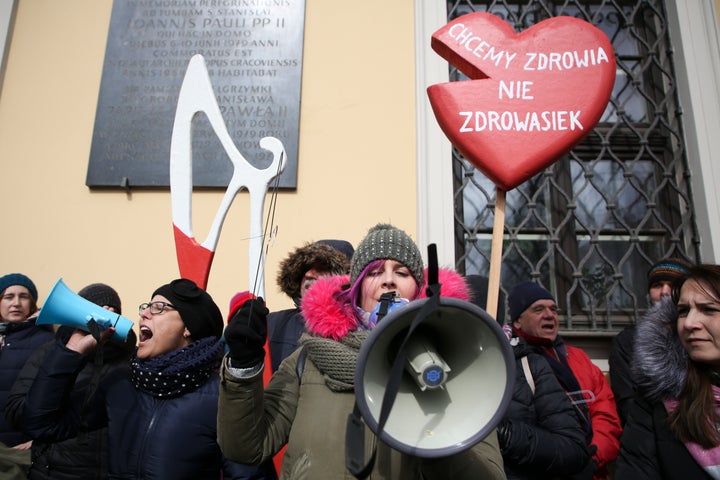 Women protest a stricter anti-abortion measure in front of archdiocese headquarters in Krakow, Poland, on March 18, 2018.