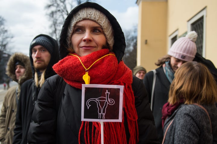 A female protester holds a sign during the demonstration in Krakow.