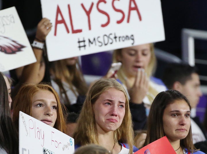 Soccer players and other students from Marjory Stoneman Douglas High School in Parkland, Florida, hold signs and wear the jersey of their former teammate, Alyssa Alhadeff, who was killed in the massacre at the school on Feb. 14. The students remembered Alyssa before the start of a She Believes Cup women's soccer match on March 7 in Orlando, Florida.