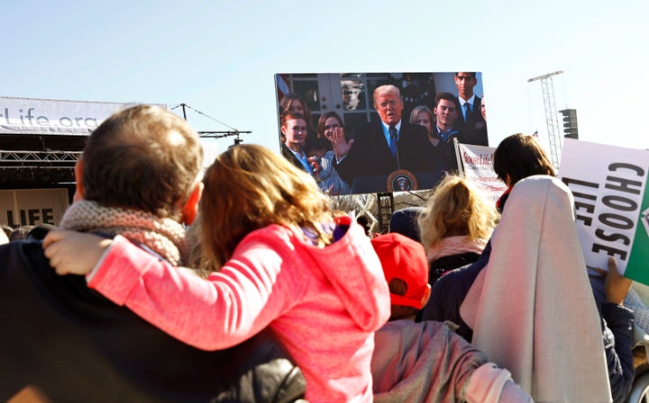 Participants watch as President Donald Trump speaks by satellite from the nearby White House to attendees of the March for Life anti-abortion rally on the National Mall in Washington, D.C., on Jan. 19.